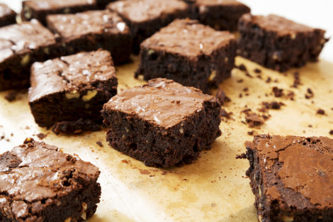 Rich and soft chocolate beer brownies on a baking sheet, side view.