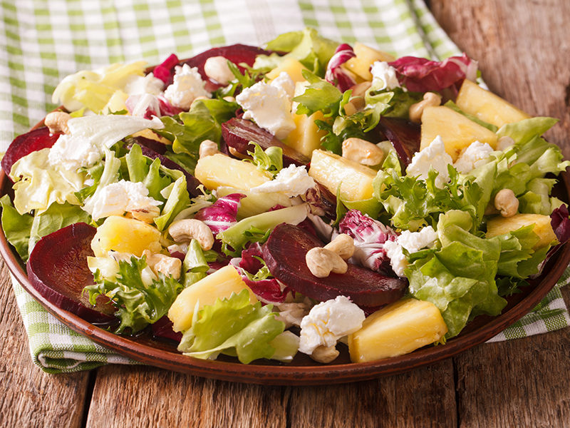 Sweet and tangy beet and pineapple salad, topped with crumbled feta cheese